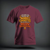 A maroon t-shirt with yellow and orange text that reads I'd like to thank the Nobel Committee for continuing to ruin Thanksgiving.