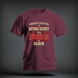 Maroon crewneck t-shirt featuring distressed text reading SOMEHOW WE WENT FROM NATIONAL SECURITY TO A NEWBORNS ASS AGAIN.