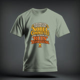Sage green t-shirt featuring yellow and orange text that reads I'D LIKE TO THANK THE NOBEL COMMITTEE FOR CONTINUING TO RUIN THANKSGIVING.