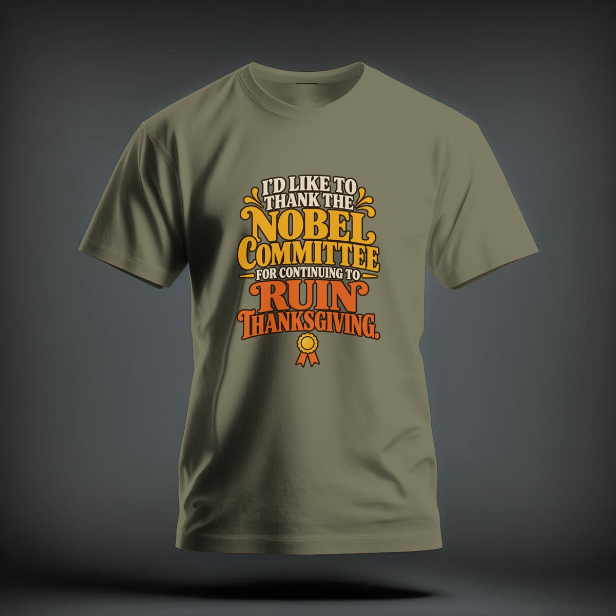 Olive green t-shirt with retro text reading "I'd like to thank the Nobel Committee for continuing to ruin Thanksgiving."