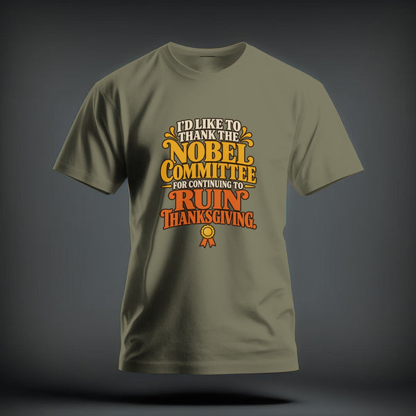 Olive green t-shirt with retro text reading "I'd like to thank the Nobel Committee for continuing to ruin Thanksgiving."