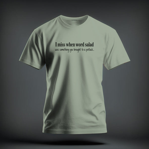 A light green crewneck t-shirt featuring the black text I miss when word salad was something you brought to a potluck.