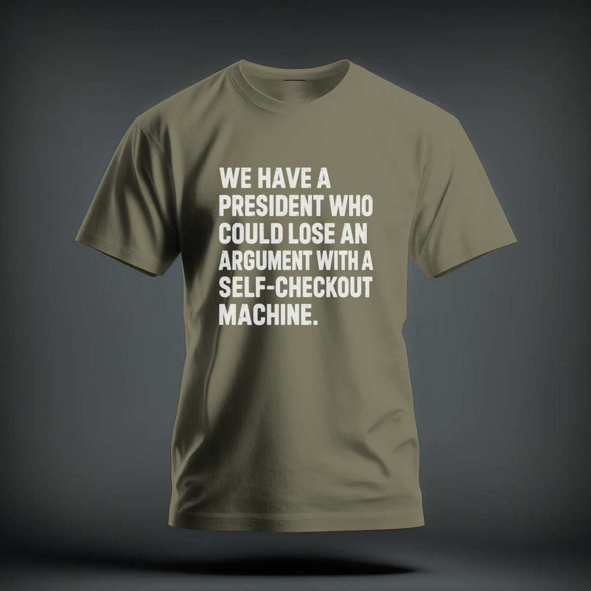 An olive green t-shirt with white printed text reading "We have a president who could lose an argument with a self-checkout machine."