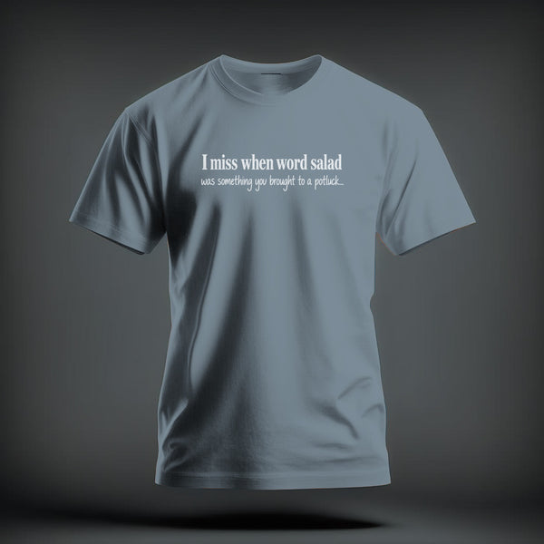 A dusty blue short-sleeve crewneck t-shirt with white text reading I miss when word salad was something you brought to a potluck.