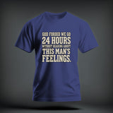 Blue short-sleeve t-shirt with beige distressed text reading GOD FORBID WE GO 24 HOURS WITHOUT HEARING ABOUT THIS MAN'S FEELINGS.