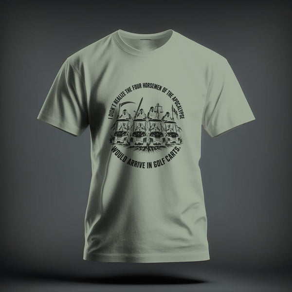 Light green crew neck t-shirt featuring a humorous graphic of the Four Horsemen of the Apocalypse riding golf carts, surrounded by curved text.