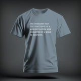 A grey crewneck t-shirt featuring centered white text that reads THE PRESIDENT HAS THE CONFIDENCE OF A MAN WHO'S NEVER BEEN CORRECTED BY A WOMAN HE RESPECTS.