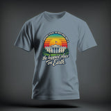 A light blue t-shirt with a graphic of the White House, a sunset, and satirical text.