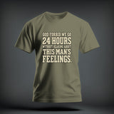 Olive green crewneck t-shirt featuring centered cream text that reads GOD FORBID WE GO 24 HOURS WITHOUT HEARING ABOUT THIS MAN'S FEELINGS.